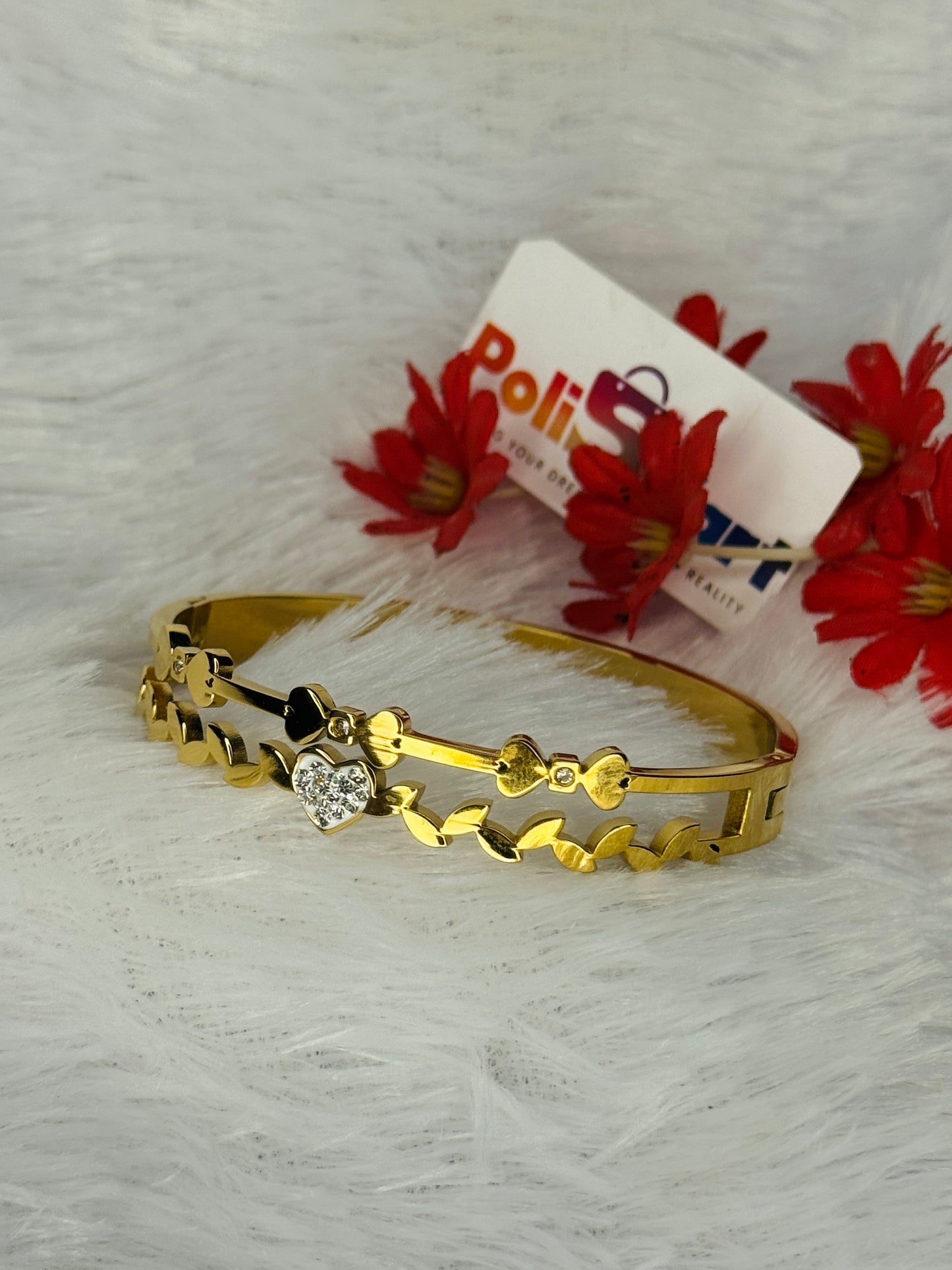 Cuff bangle with single white stone heart design