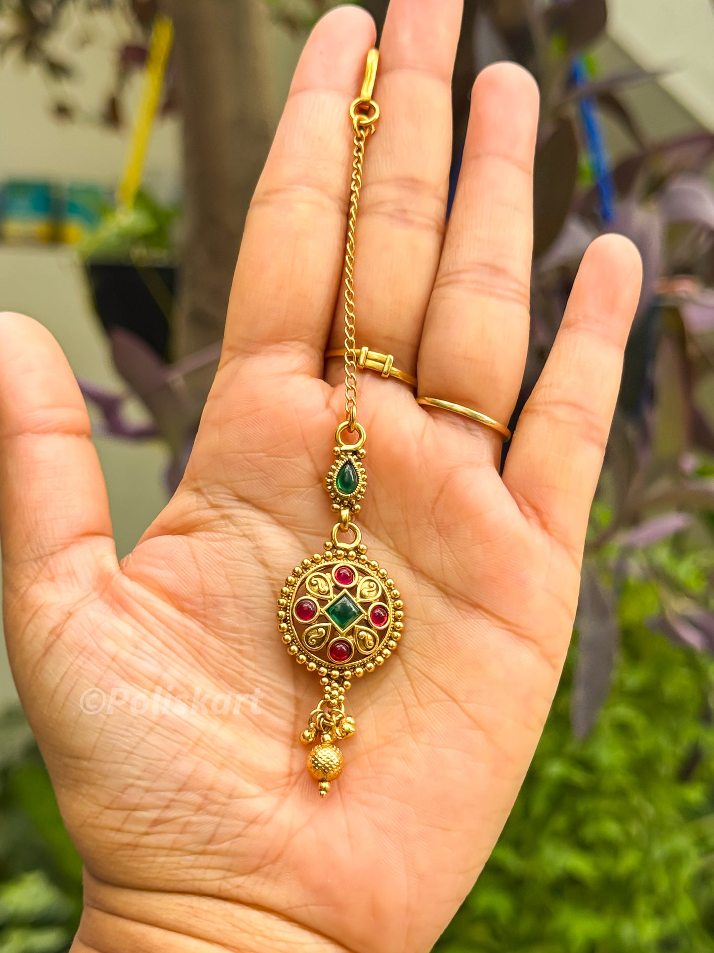 Tikka - ruby and green stone worked golden design