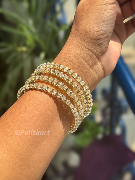 4 White stone worked metal bangles