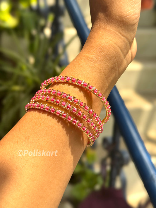 4 Rubi stone worked metal bangles