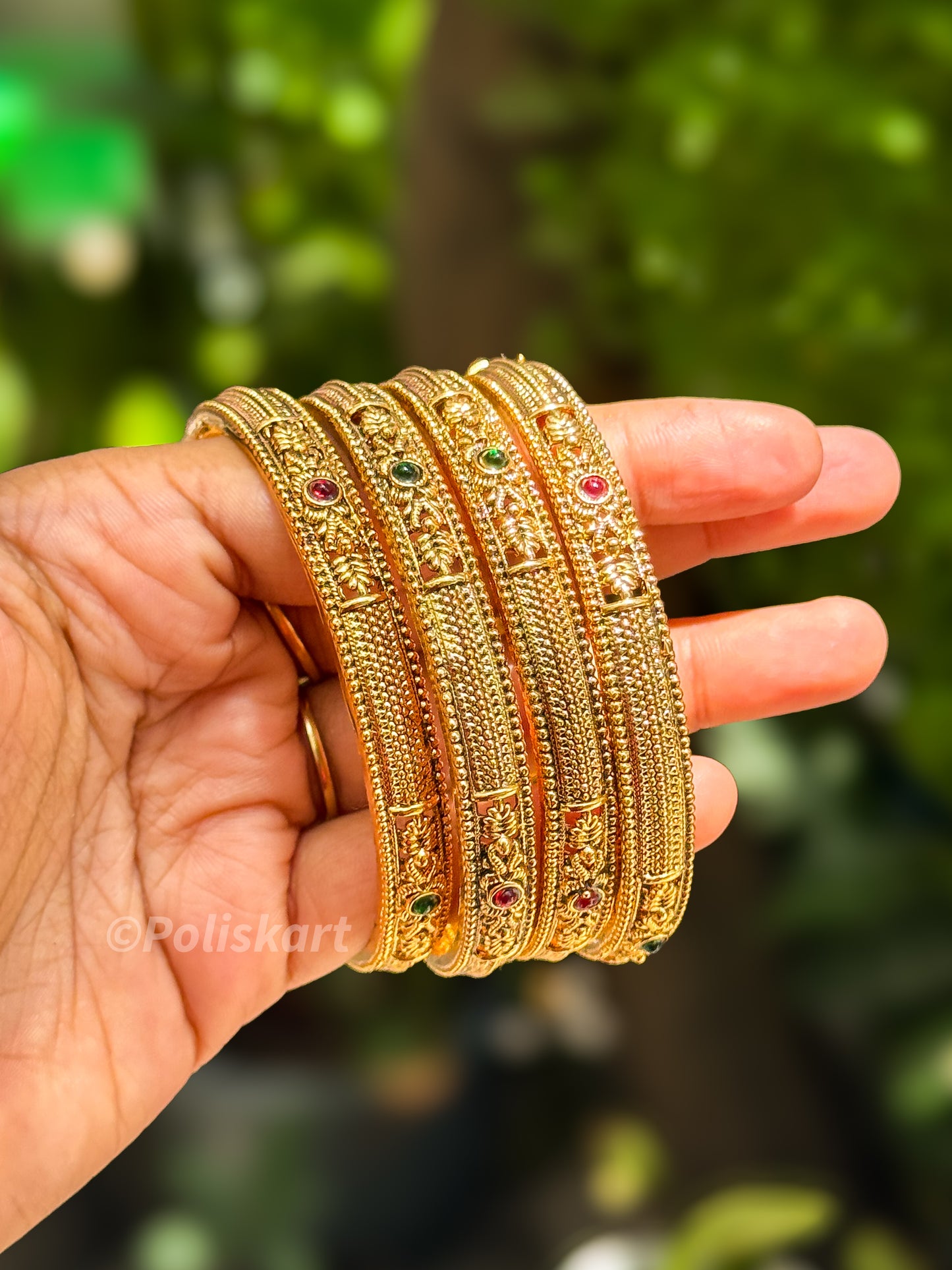 Four bangle with ruby and green design
