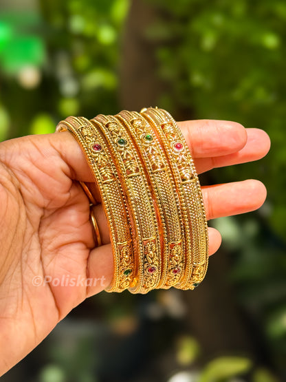 Four bangle with ruby and green design