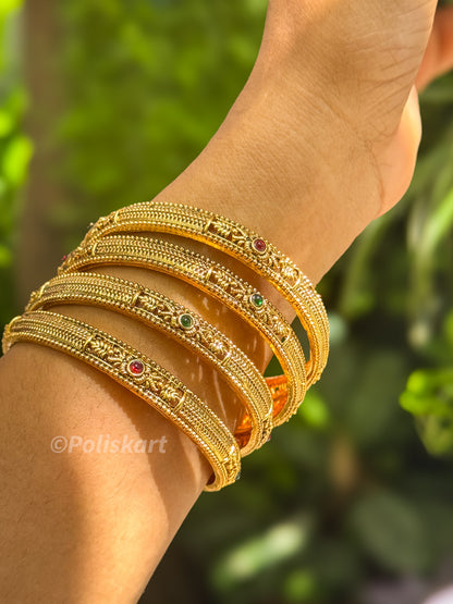 Four bangle with ruby and green design