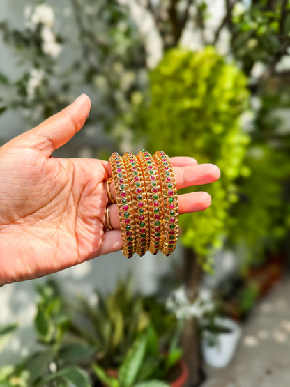 4 bangles with  Rubi and green stone worked design