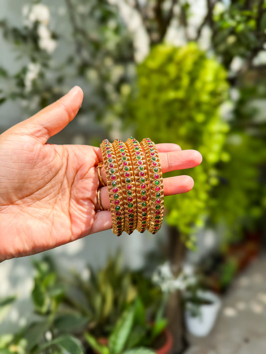 4 bangles with  Rubi and green stone worked design
