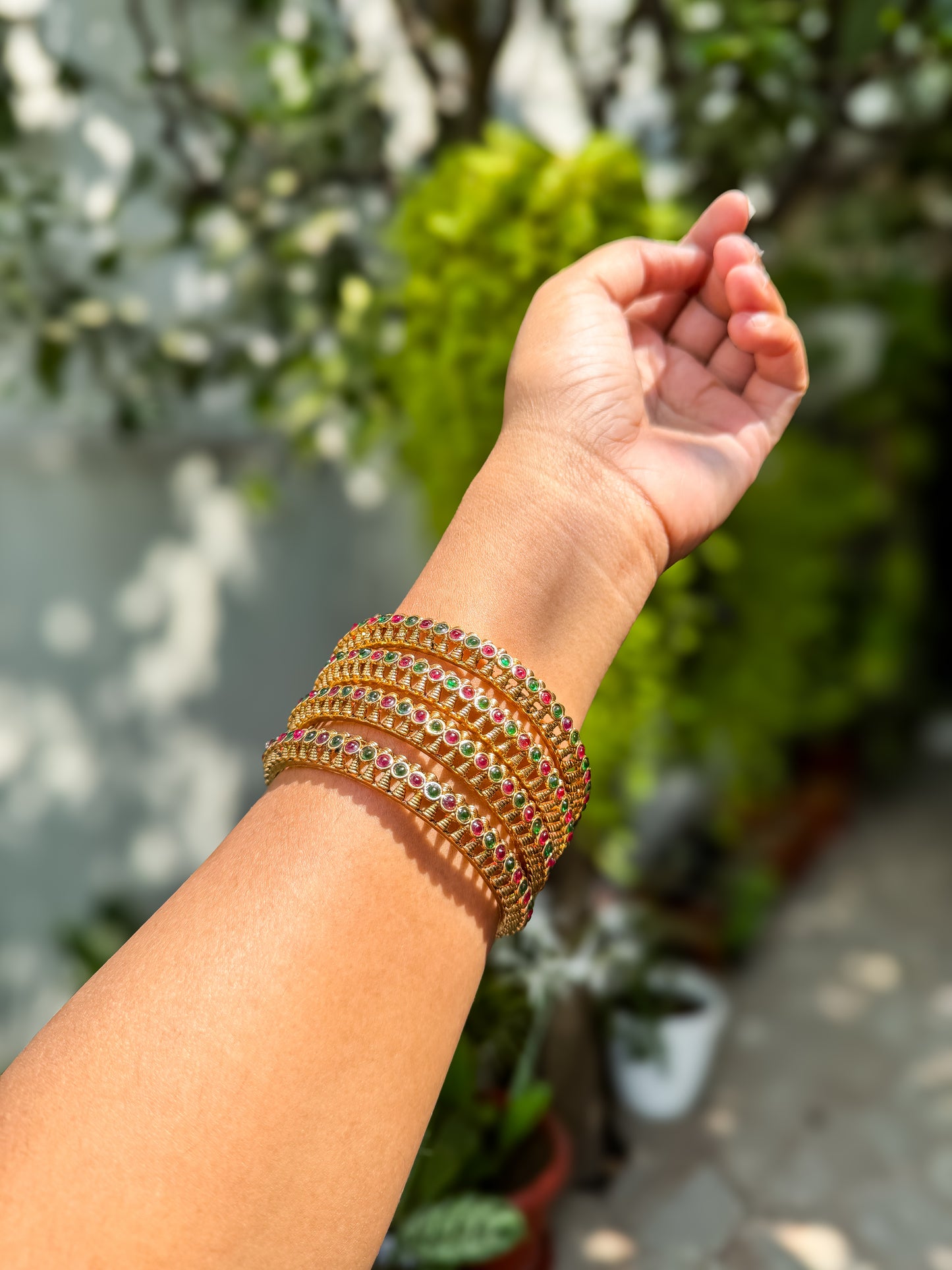 4 bangles with  Rubi and green stone worked design