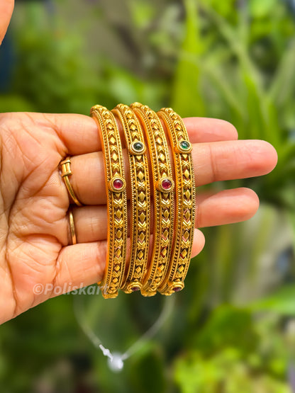 4 bangles with rubi and green stone worked design