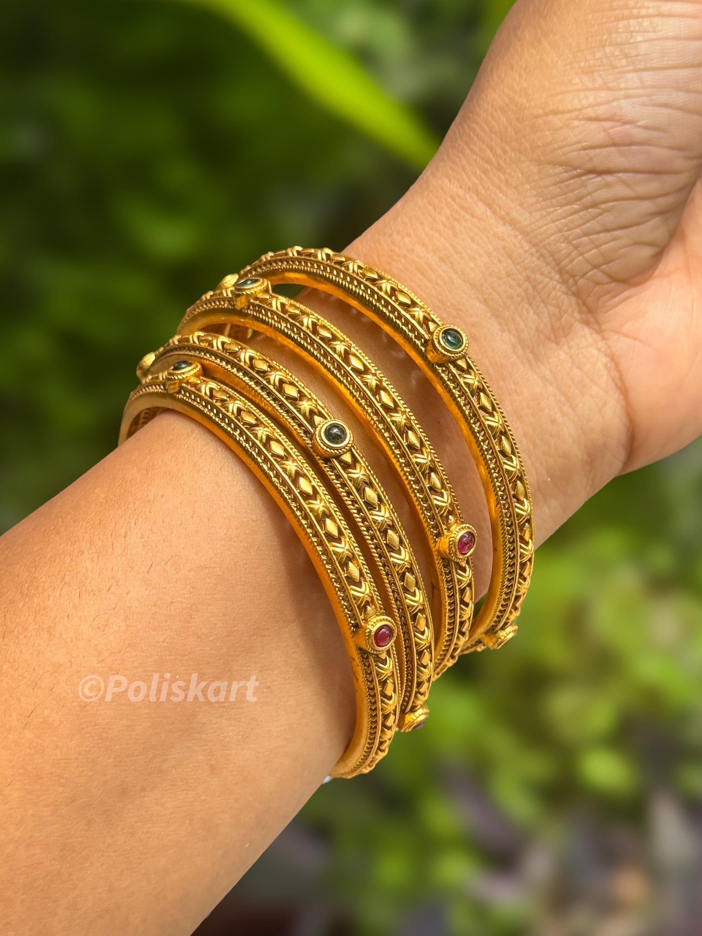 4 bangles with rubi and green stone worked design