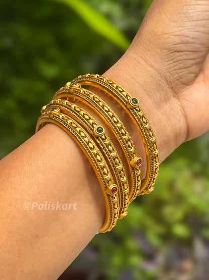 4 bangles with rubi and green stone worked design