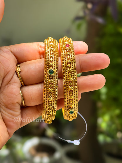 Pair of bangles with rubi and red stone worked design