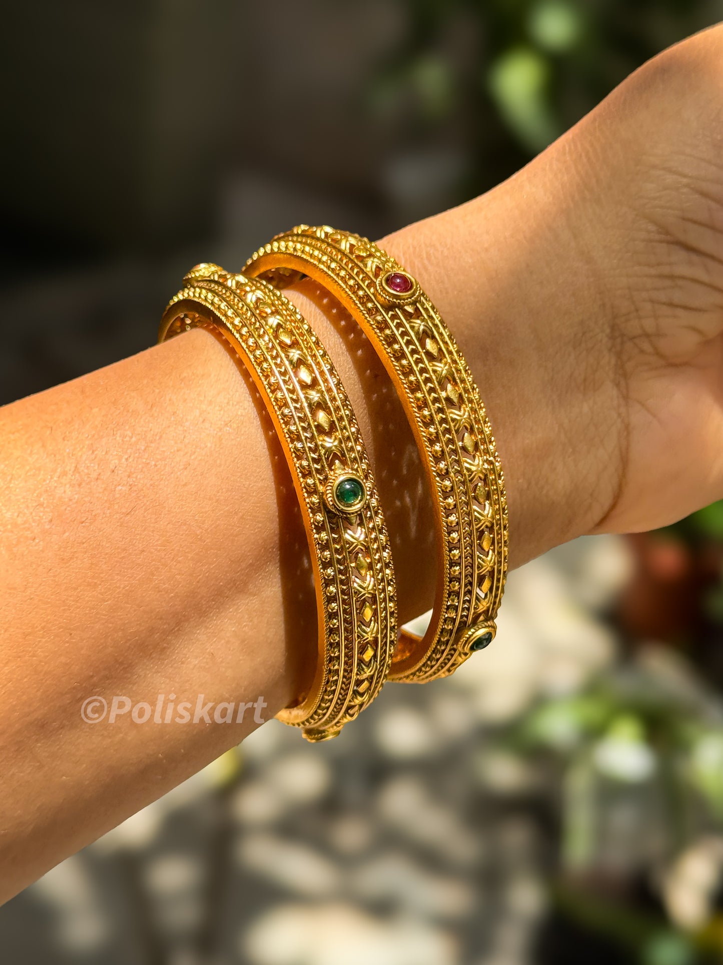 Pair of bangles with rubi and red stone worked design