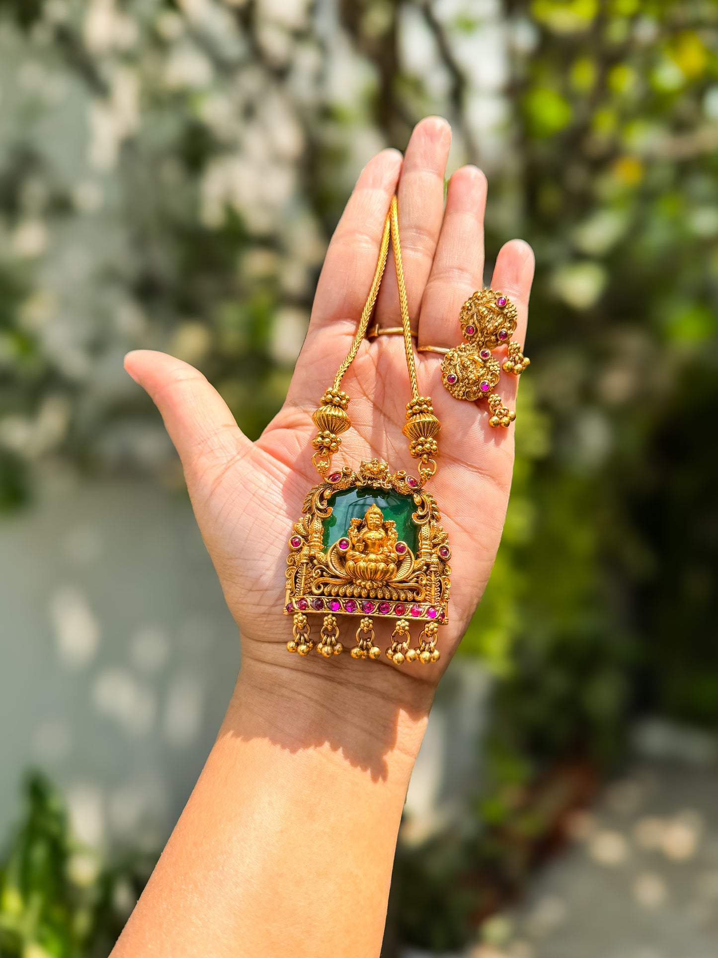 Chain with green enamel highlighted lakshmi pendant