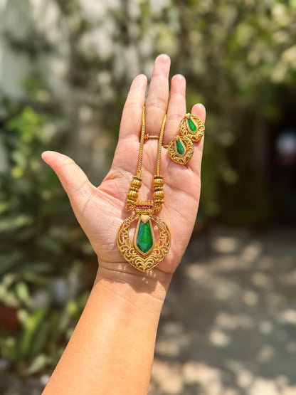 Green stone highlighted pendant with chain and earring set