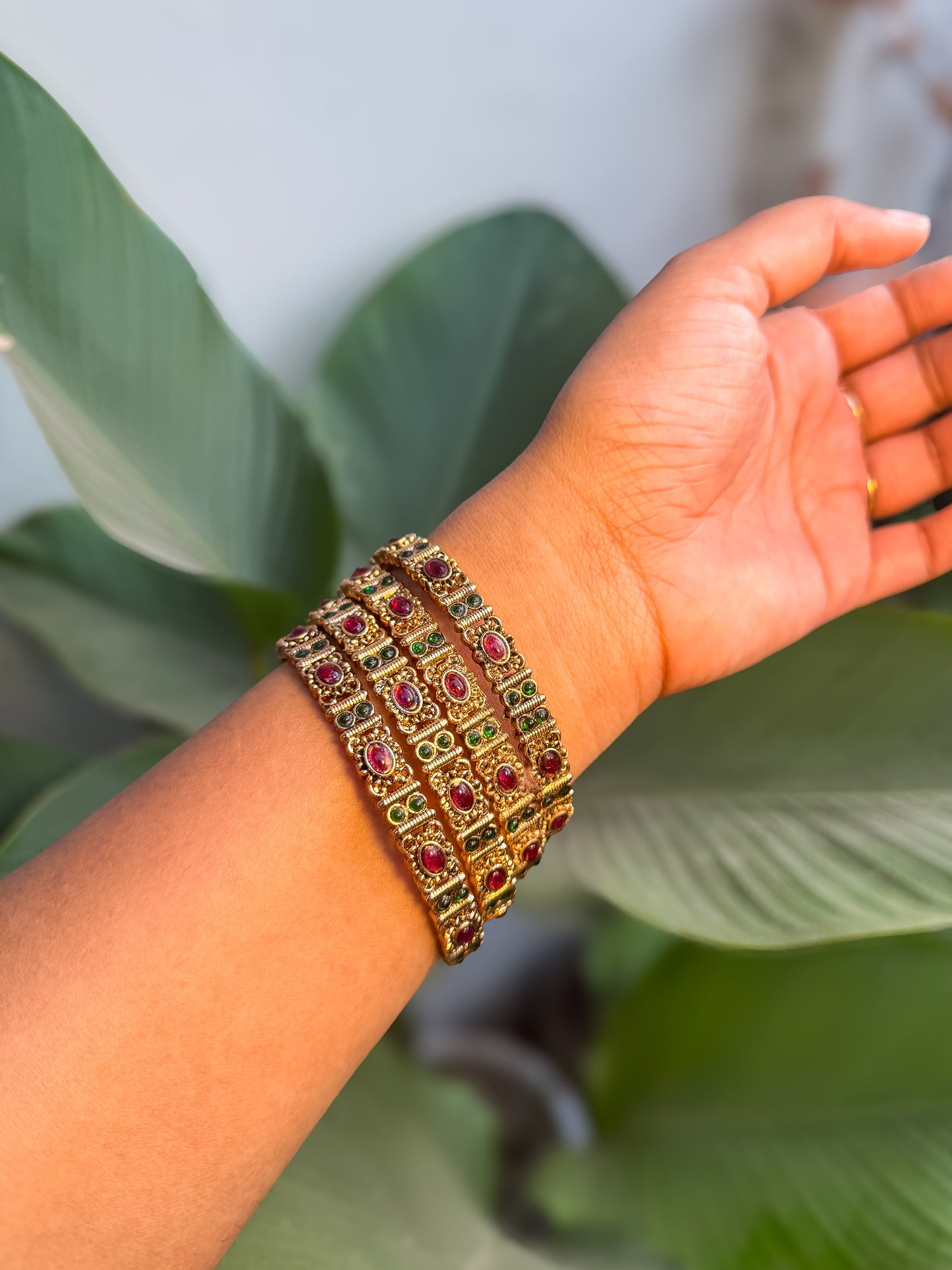 4 bangles with Green and  red stone worked design