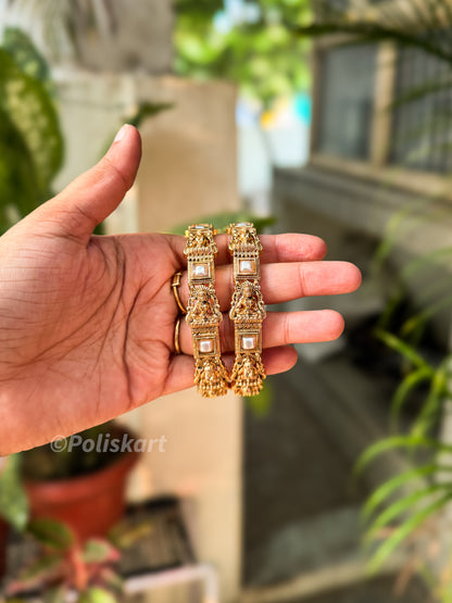 Pair of white pearl and lakshmi worked bangles