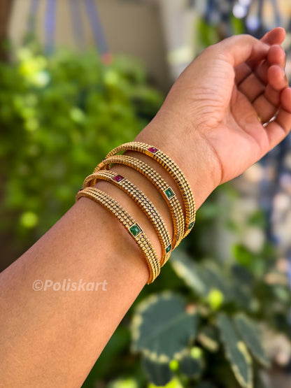 4 bangles with gold finished design
